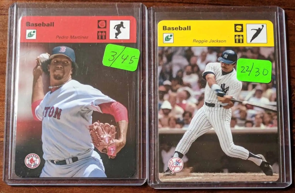 Vintage baseball cards of Pedro Martinez and Reggie Jackson protected in hard plastic toploaders
