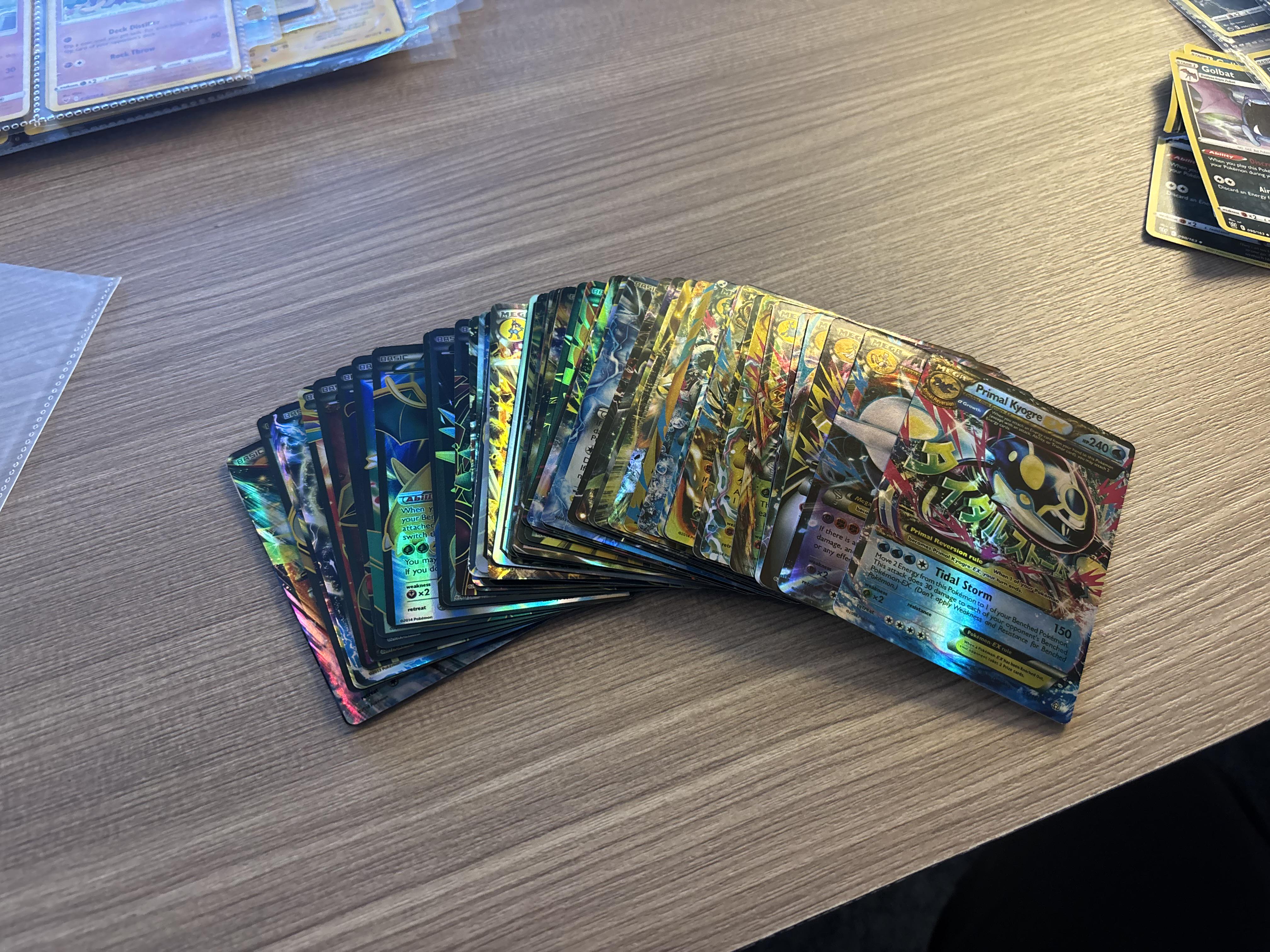 A spread of fake Pokemon GX and EX cards from a Facebook Marketplace mystery box