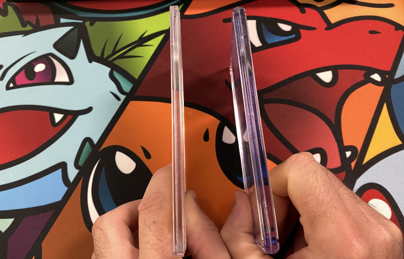 PSA and CGC slabs from the side — CGC's thicker construction is visible next to PSA's slimmer profile